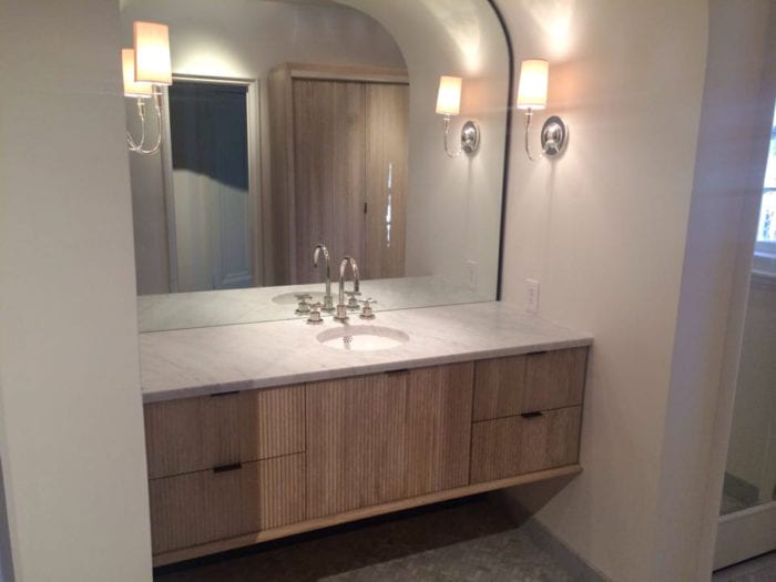 fluted vanity with steel framed arched mirror