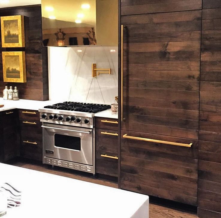 Warm Walnut Kitchen with Gold Details and Stainless Steel Appliances