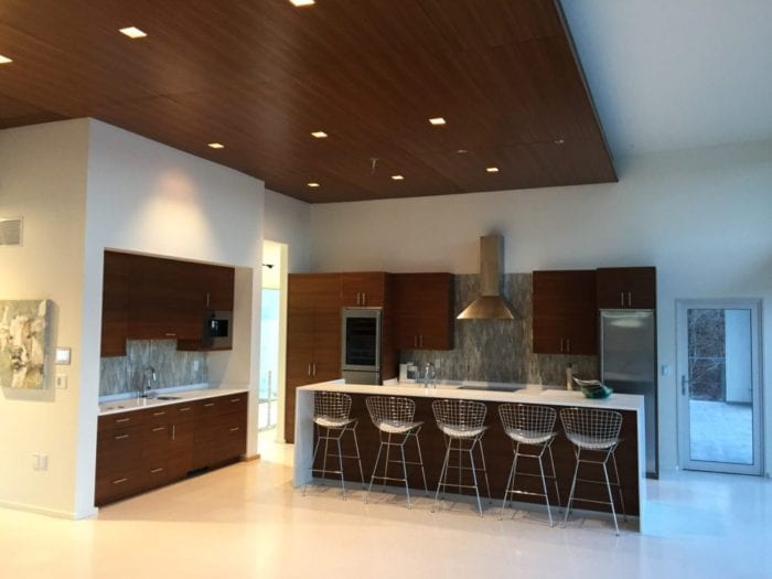 Sleek and Modern White Kitchen with Walnut Cabinetry