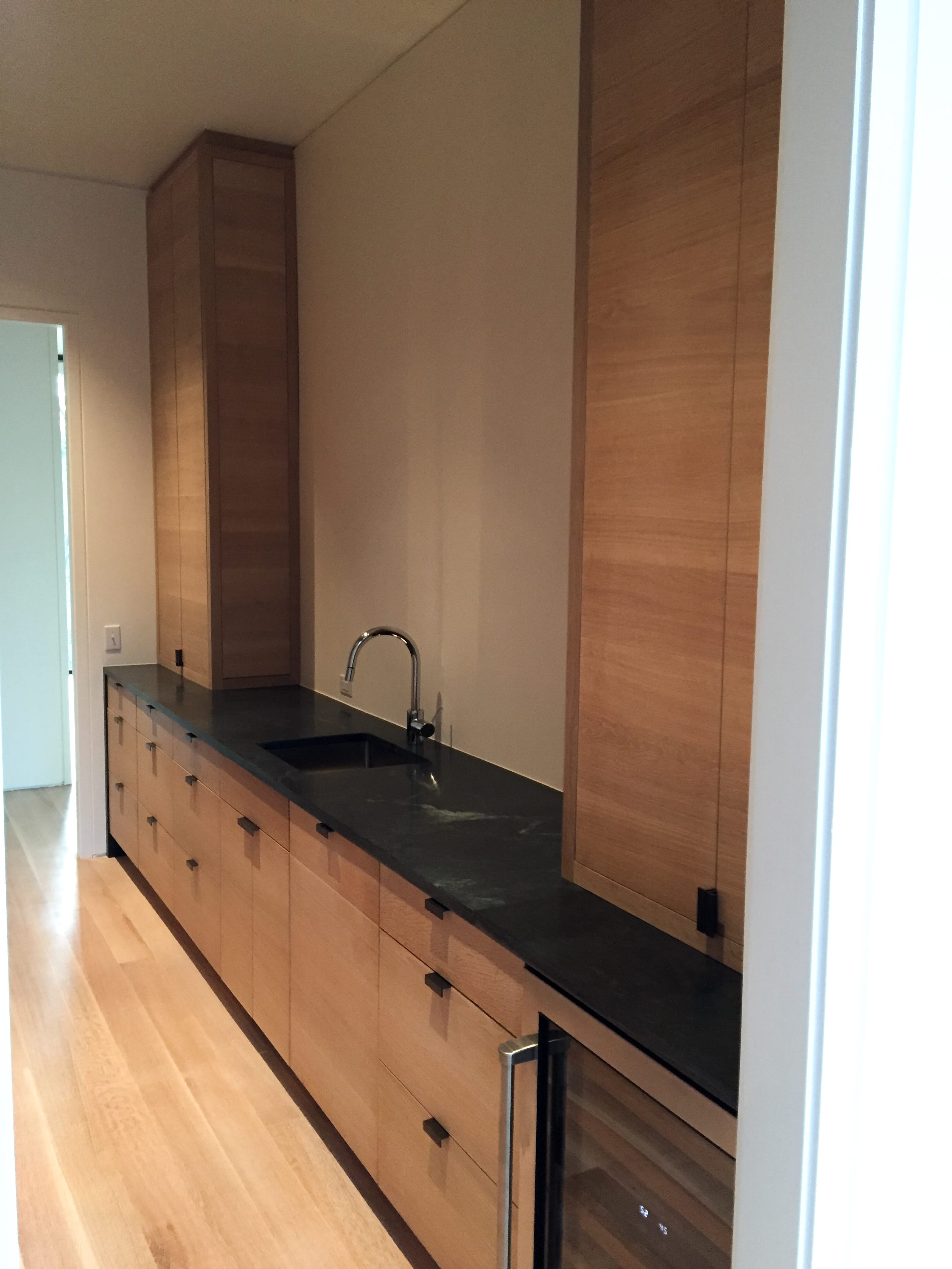 Modern Oak Kitchen with Black Countertops side view
