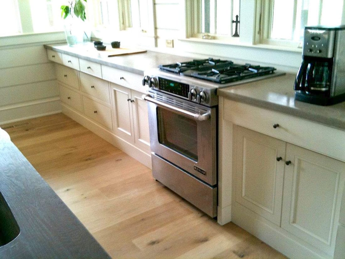 White Kitchen with Granite Countertops and Stainless Steel Appliances