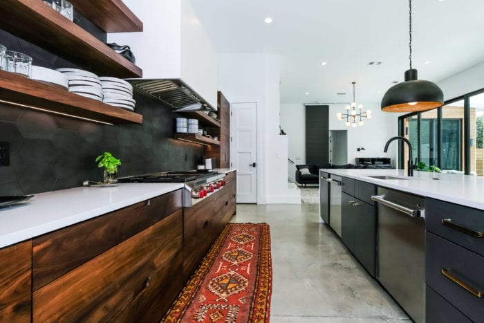 Black, White, and Walnut Kitchen with stainless steel appliances