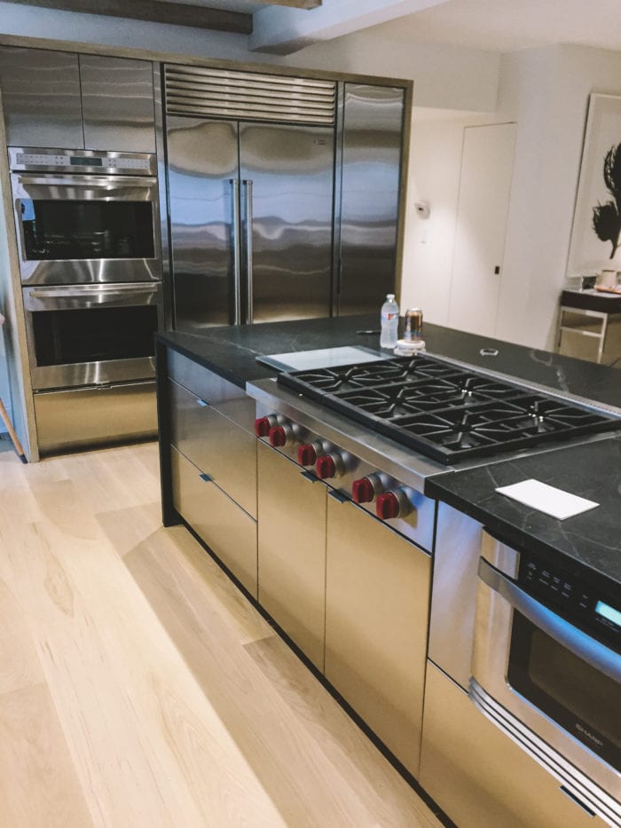 Custom stainless steel and black marble kitchen