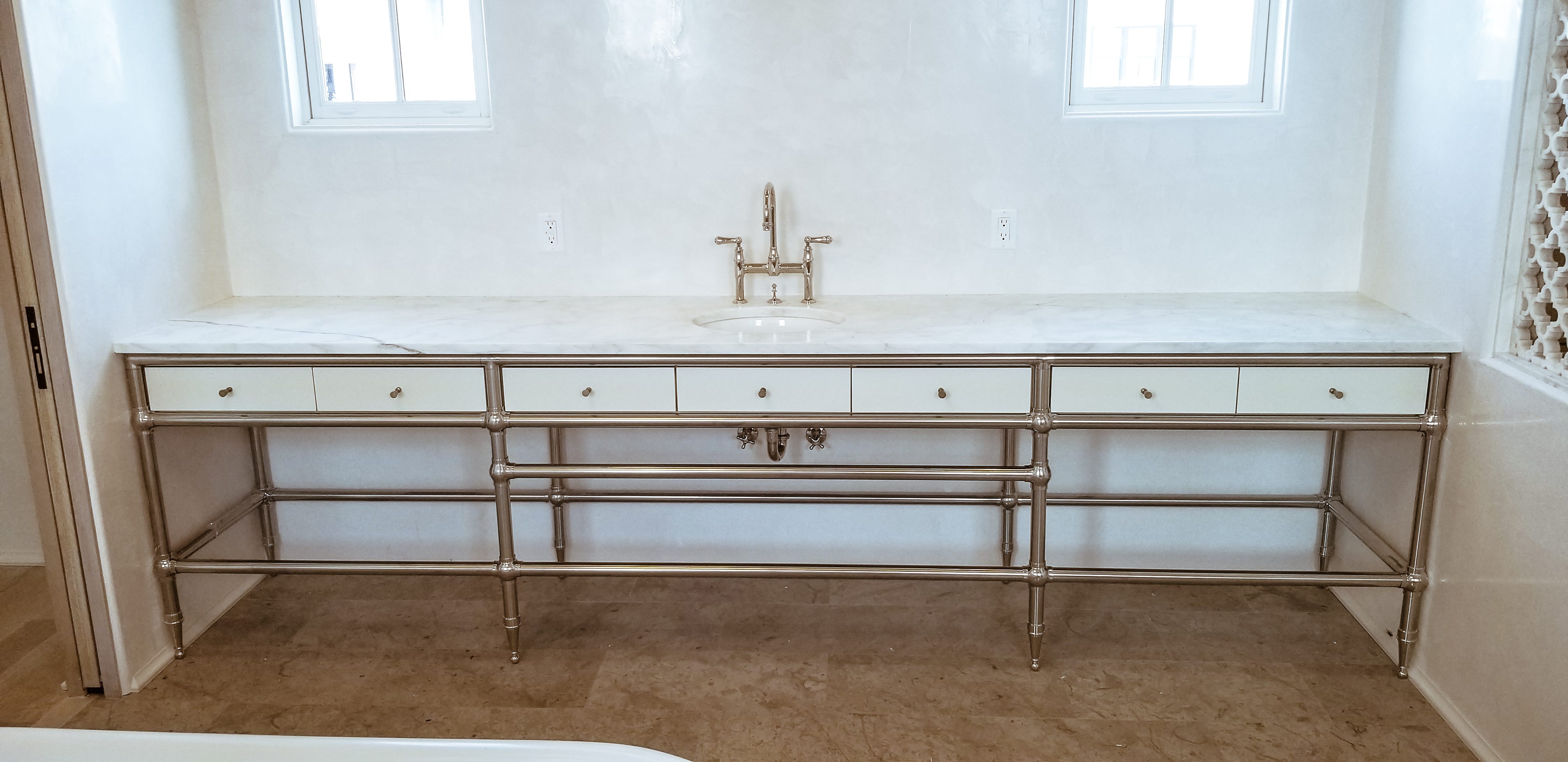 White vanity with metal rod detailing front view