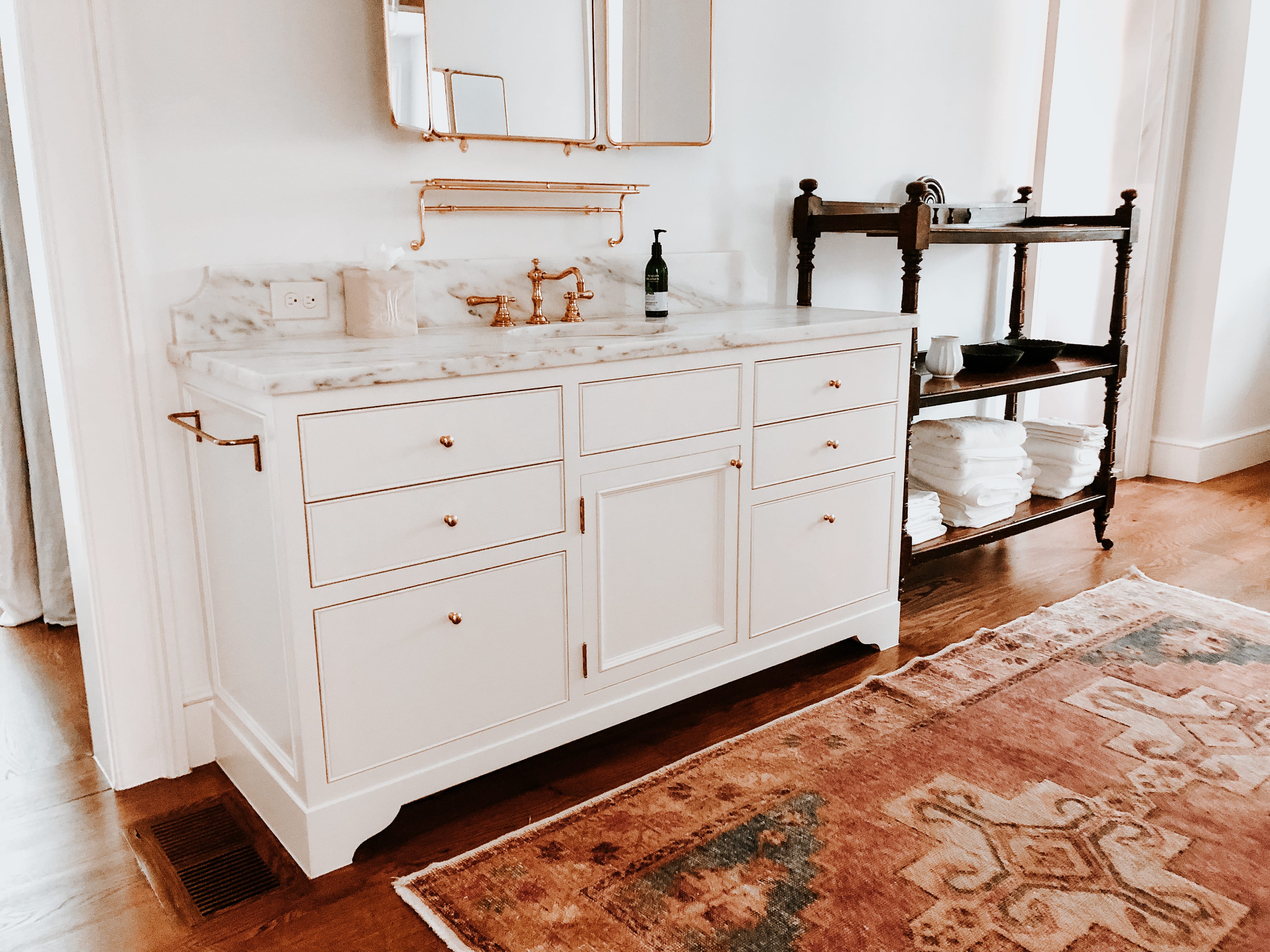 Timeless White Vanity with gold detailing and marble countertop side view