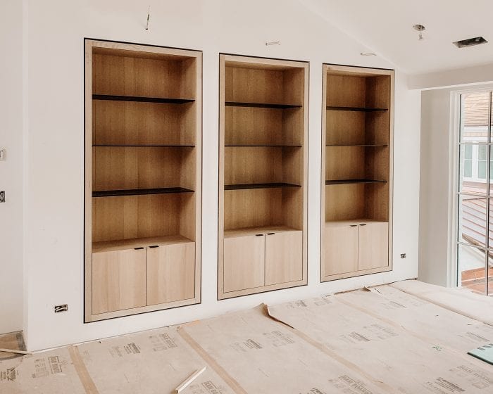 Built in wooden shelving with black details