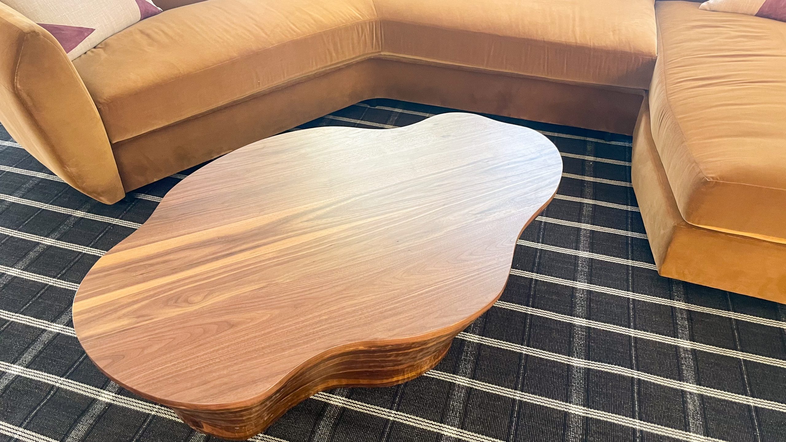 Organic shaped walnut coffee table close up