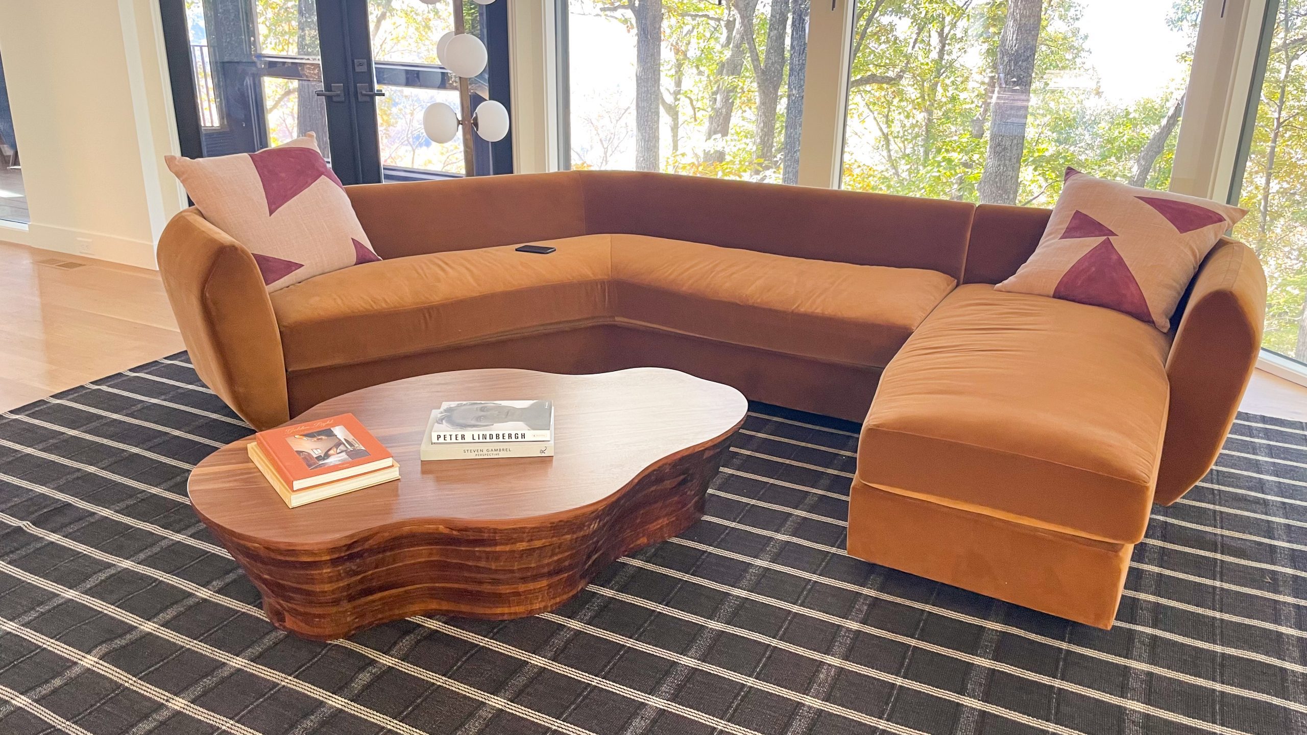 Organic shaped walnut coffee table with couch