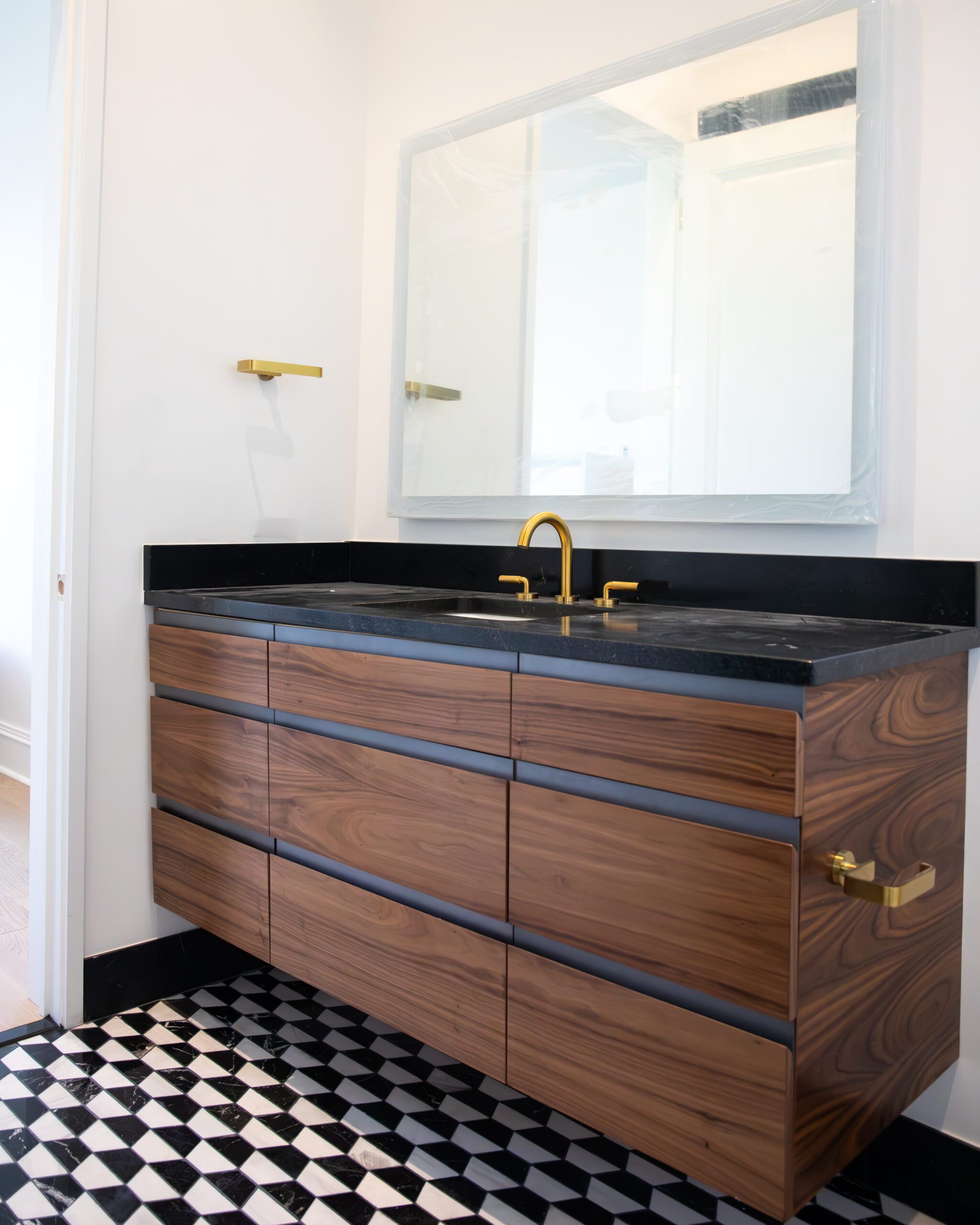 LED mirrors add a pop above this freshly installed walnut vanity we designed and made for a New Orleans home. ⁠