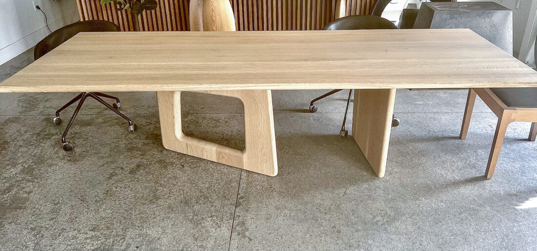 Modern rectangular oak table with a sleek minimalist design.