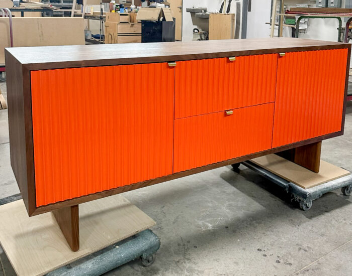 custom walnut credenza with orange doors