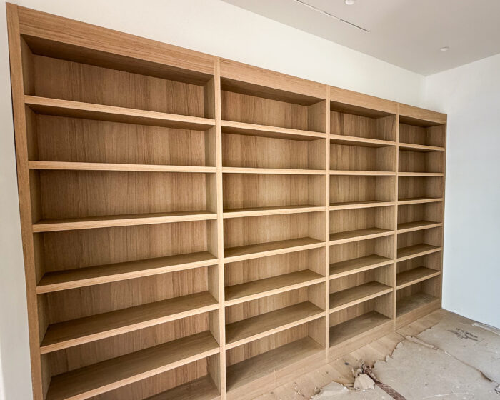 Built-in white oak bookcase with adjustable shelves and smooth finish