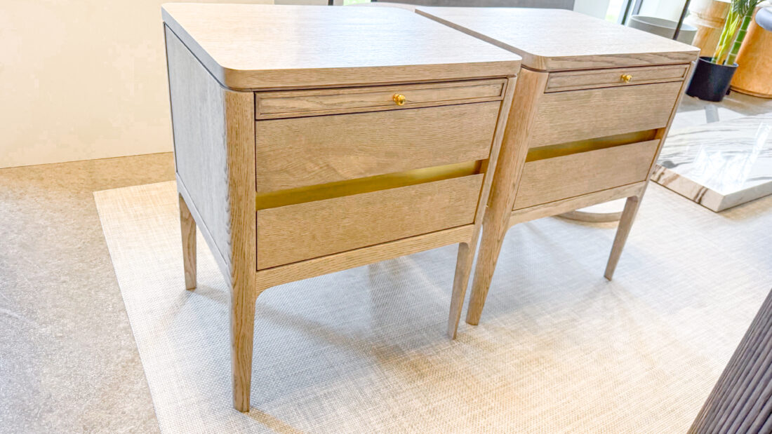 Pair of oak nightstands with brass accents and round gold knobs