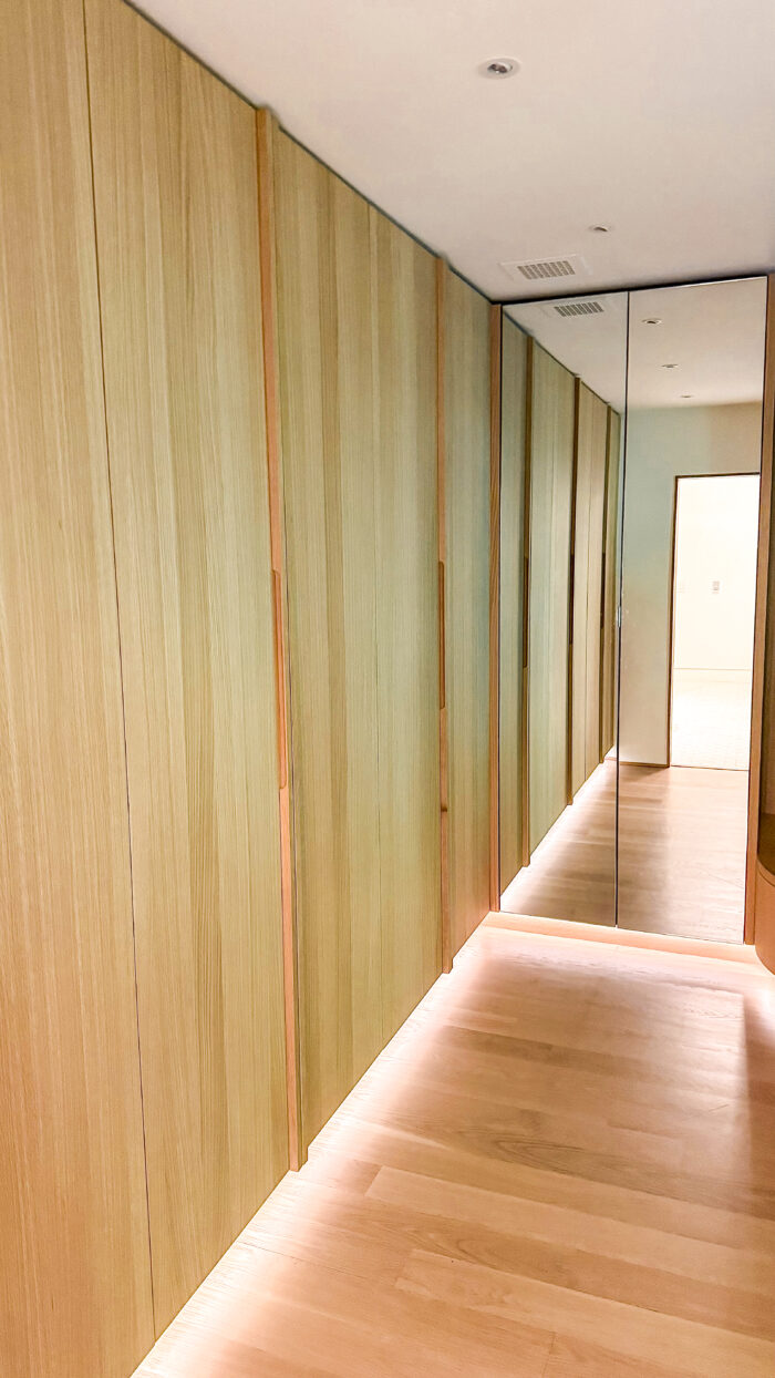 A well lit custom closet with plenty of room