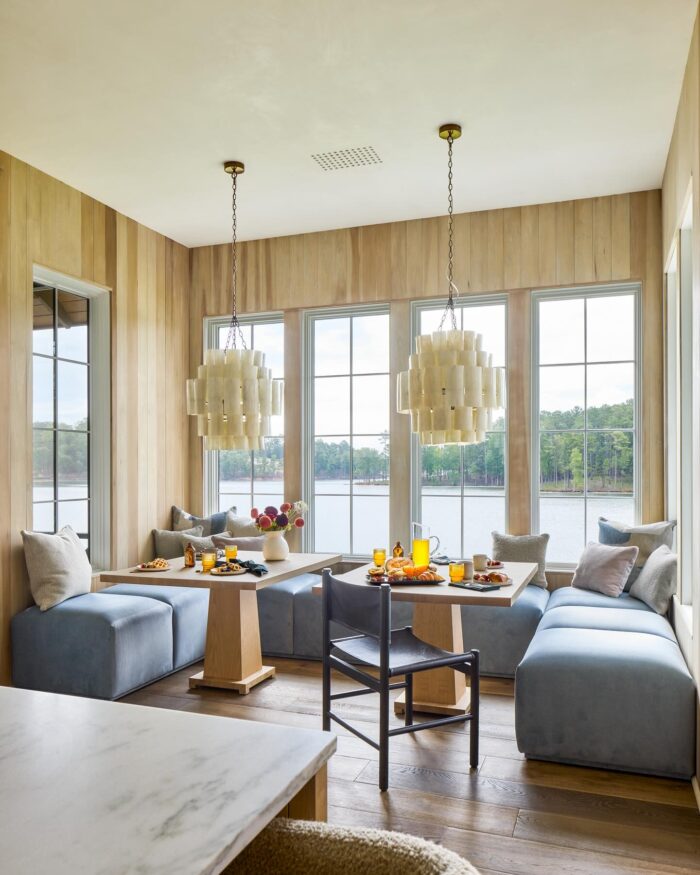 Matching custom tables in cozy breakfast nook with banquette seating
