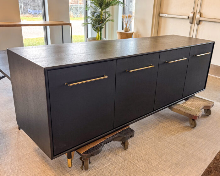 Sleek Wooden TV Cabinet with black finish and brass handles